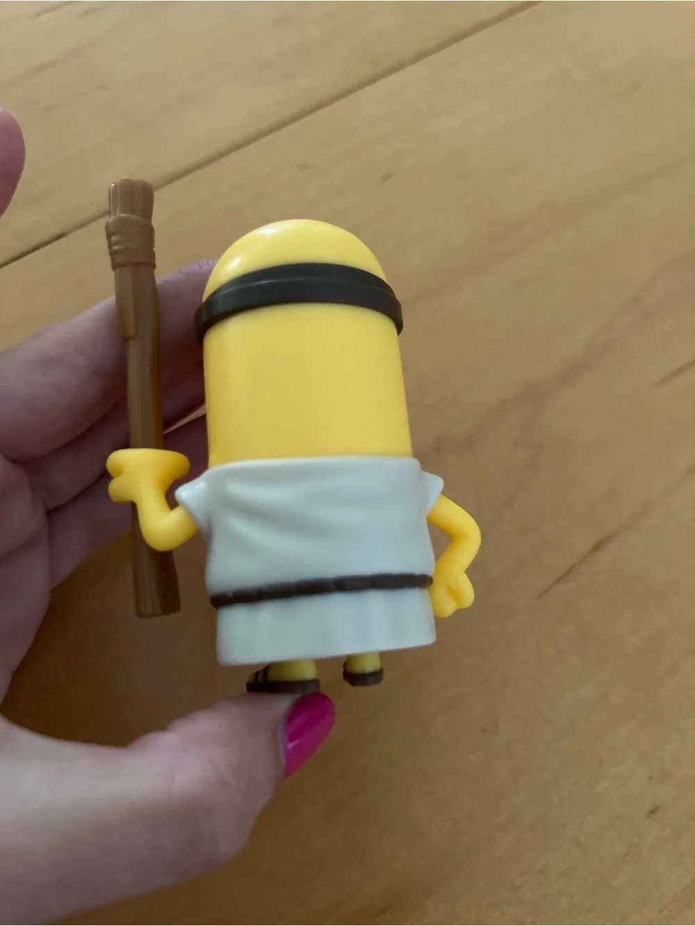 One-Eyed Yellow Action Figure with Brown Staff - Classic Cartoon Style